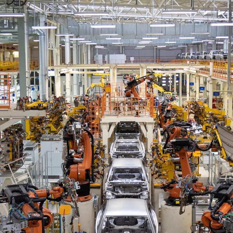 Assembly line production of new car. Automated welding of car body on production line. robotic arm on car production line is working. Wide format shooting automotive. Car factory banner